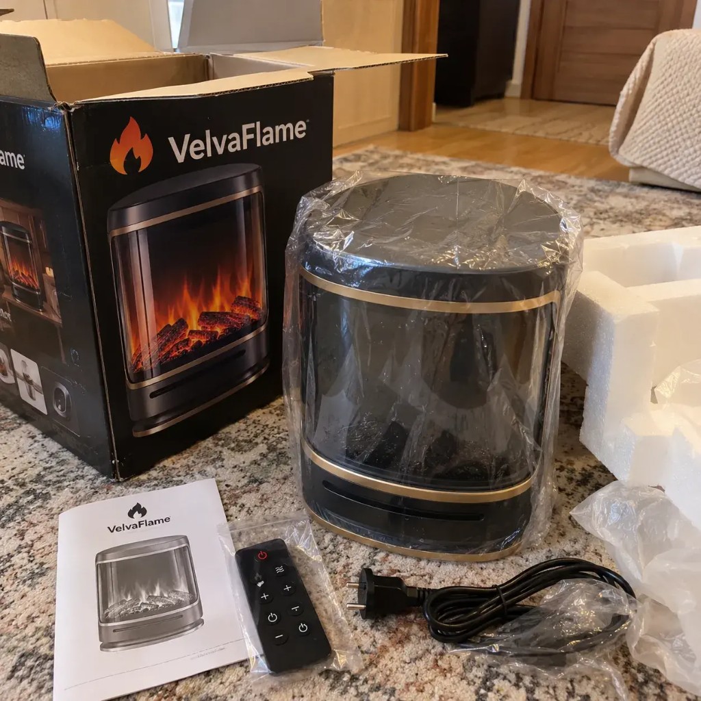 VelvaFlame disimballato con scatola, manuale e telecomando IR sul piano cucina